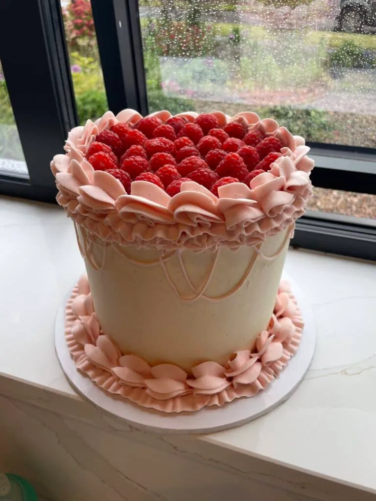 Raspberry topped, buttercream birthday cake